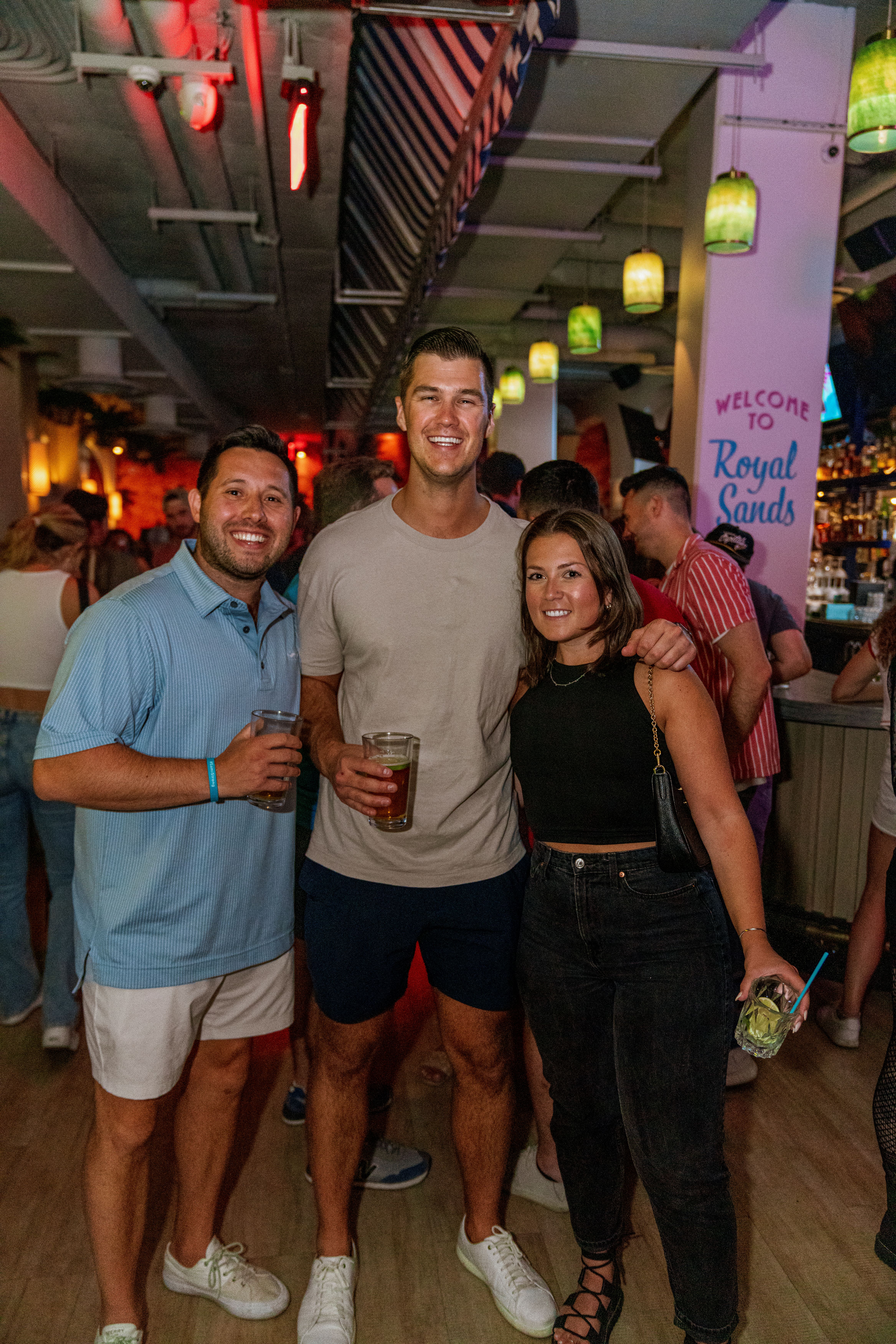 a group of people standing in front of a crowd posing for the camera