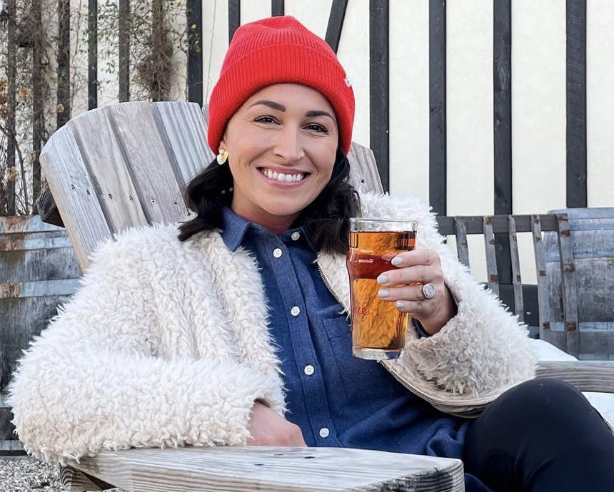 a woman holding a beer