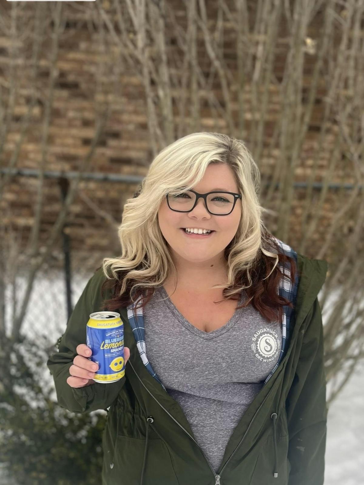a woman holding a beer
