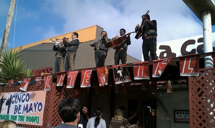 Tony Curtis et al. riding on the back of a truck