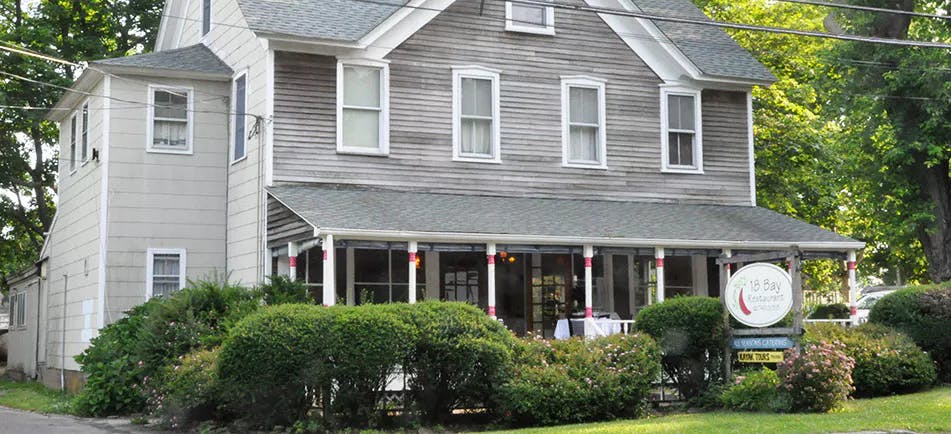 a large brick building with grass in front of a house