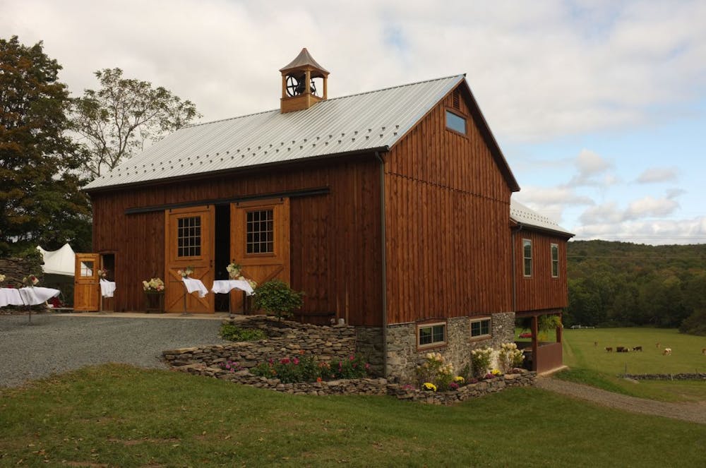 a large brick building with grass in front of a house