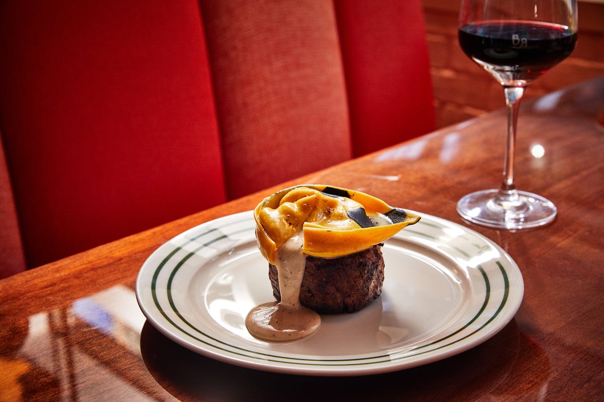 a plate of food and a glass of wine