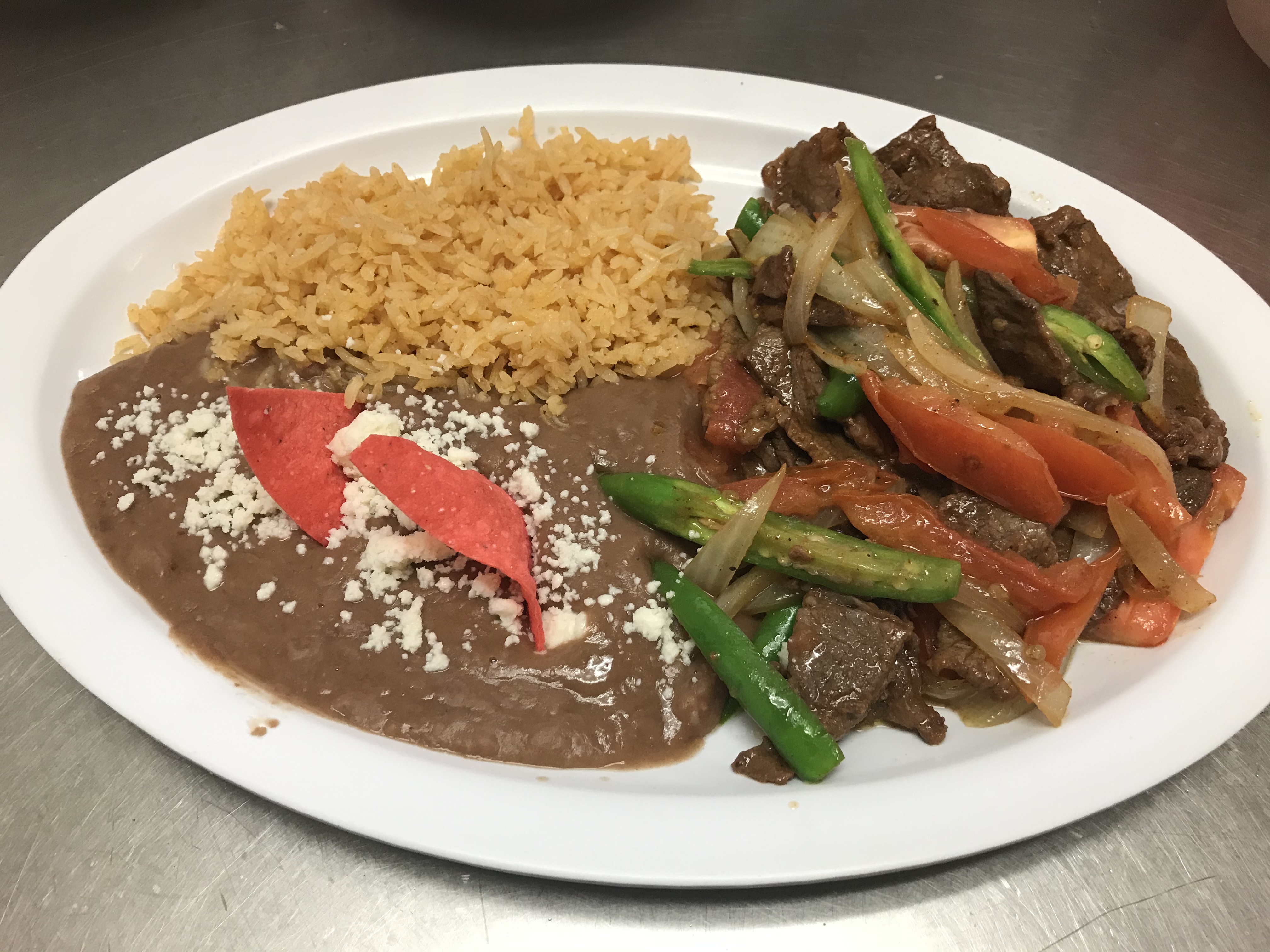 a plate of food with rice meat and vegetables
