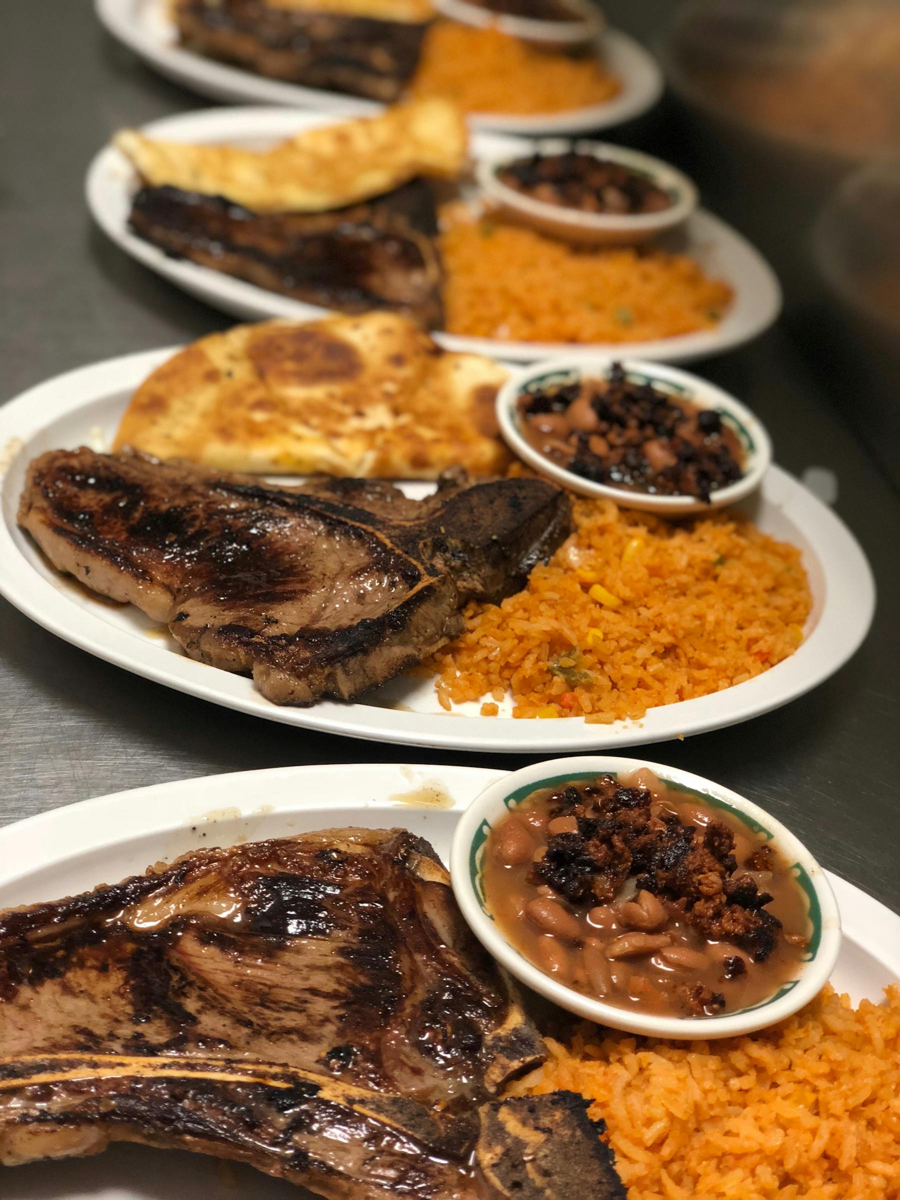 pork chops with rice and beans on the side