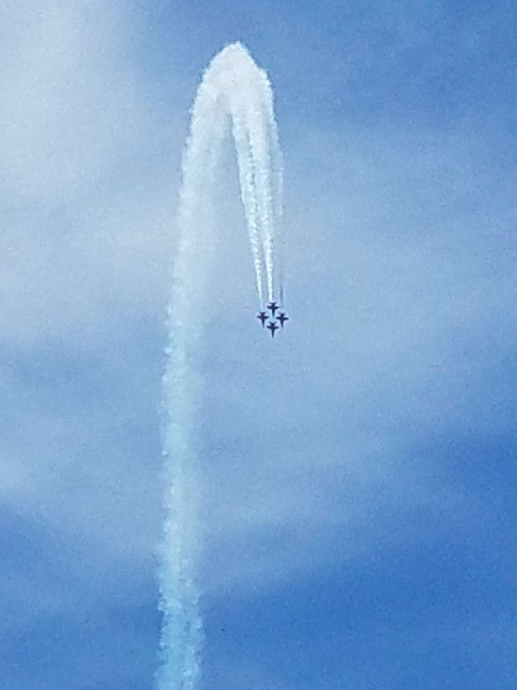 a plane flying in the air with smoke coming out of it