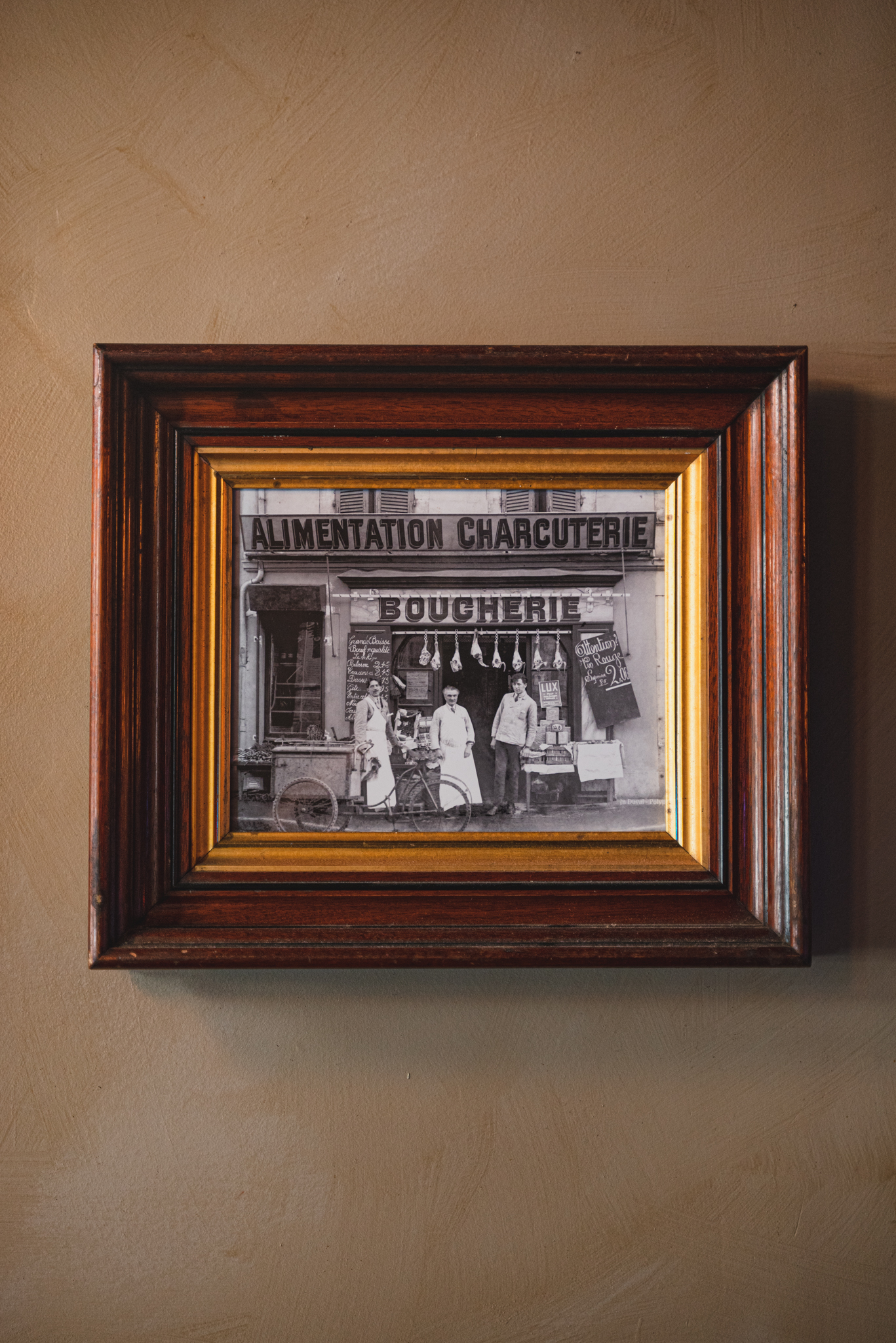 a painting in a frame hanging on a wall