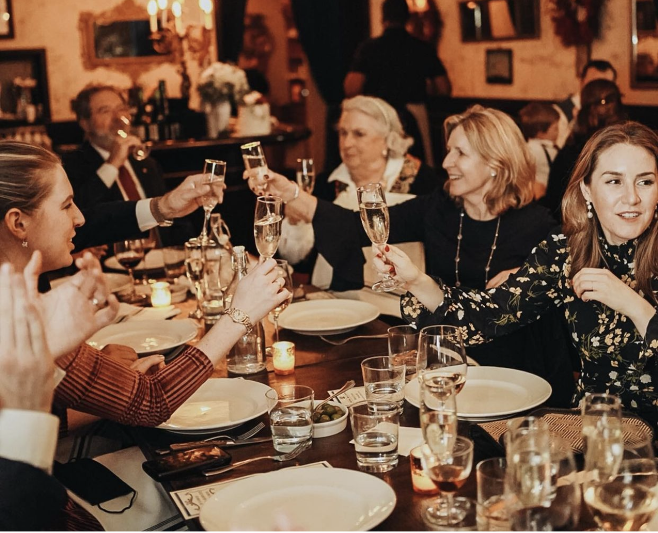 a group of people sitting at a dinner table