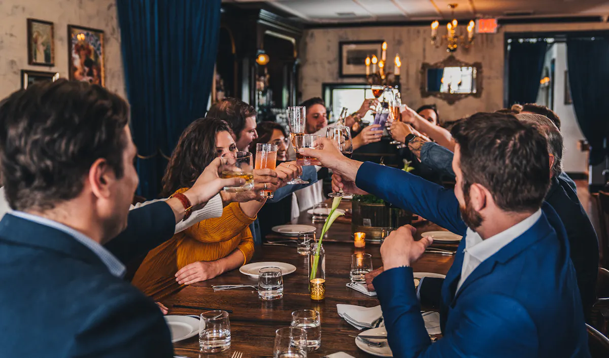 a group of people sitting at a table with wine glasses