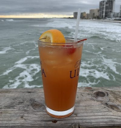 a glass of orange juice next to a cup of water