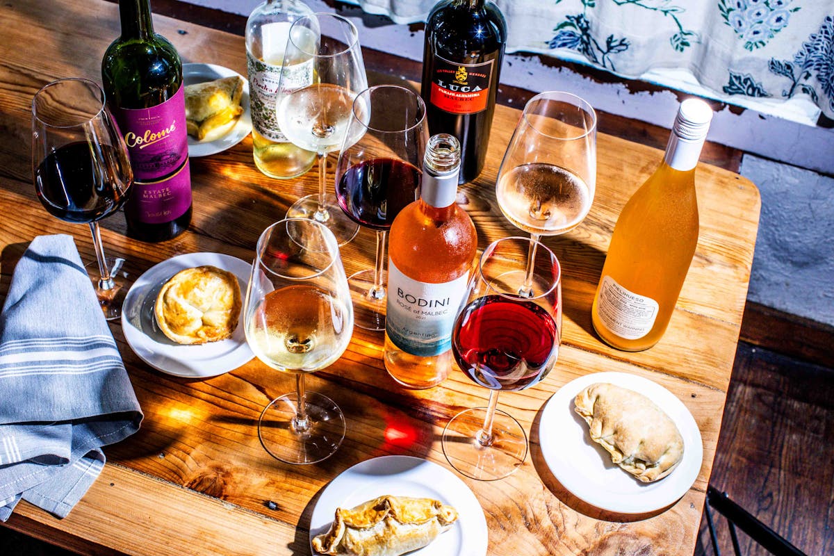 a plate of food and a bottle of wine on a table