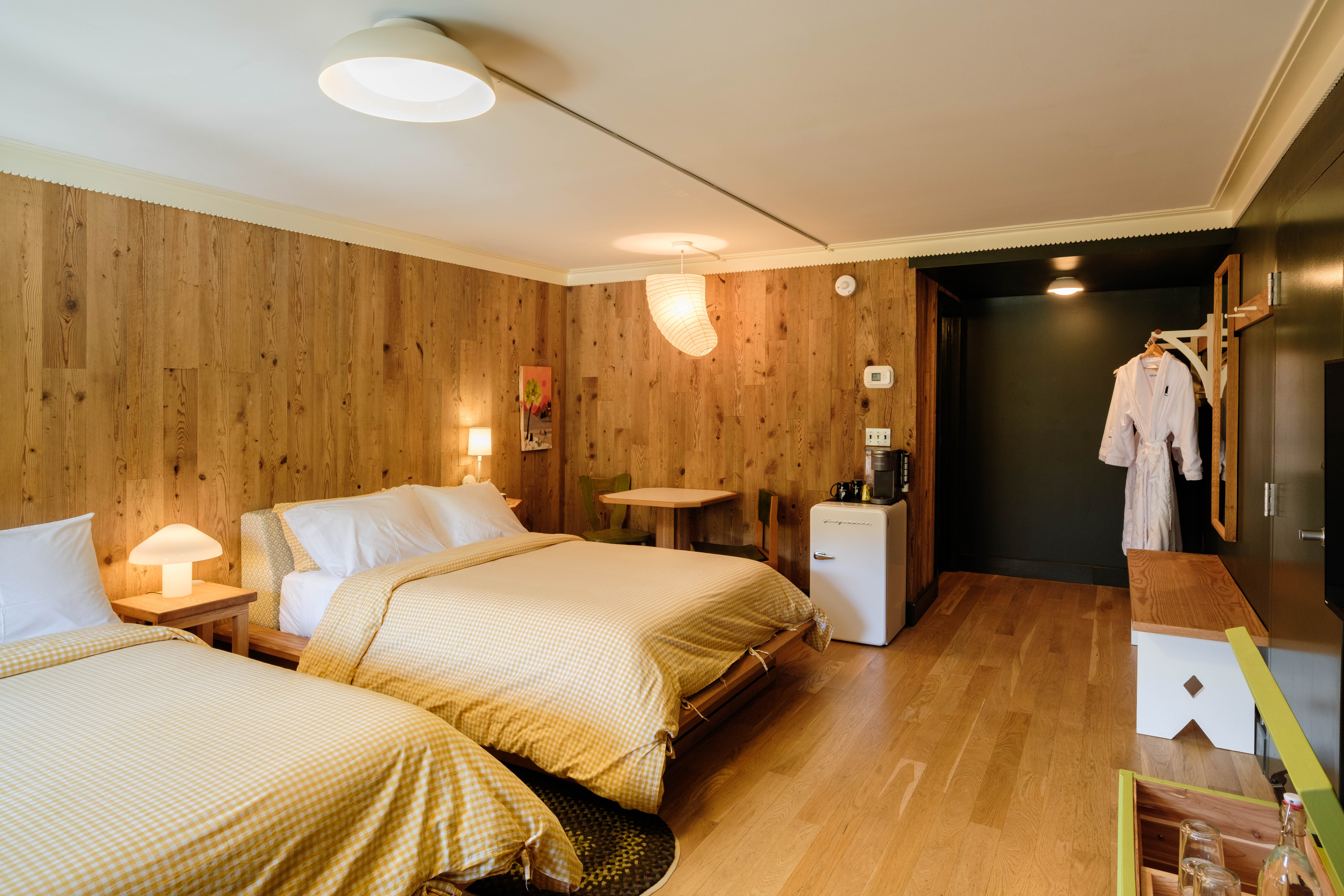 a bedroom with a bed and desk in a room