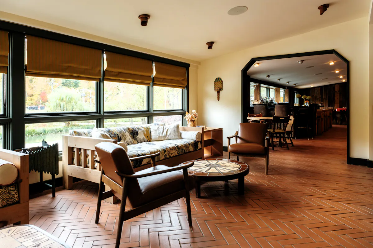 a living room filled with furniture and a large window