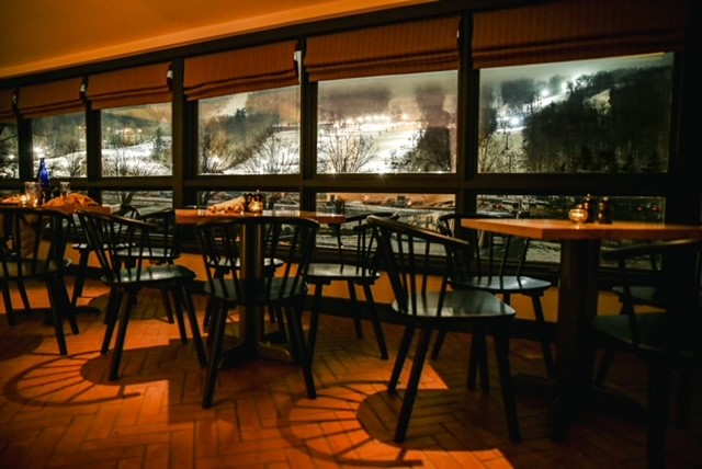 a dining room table in front of a window