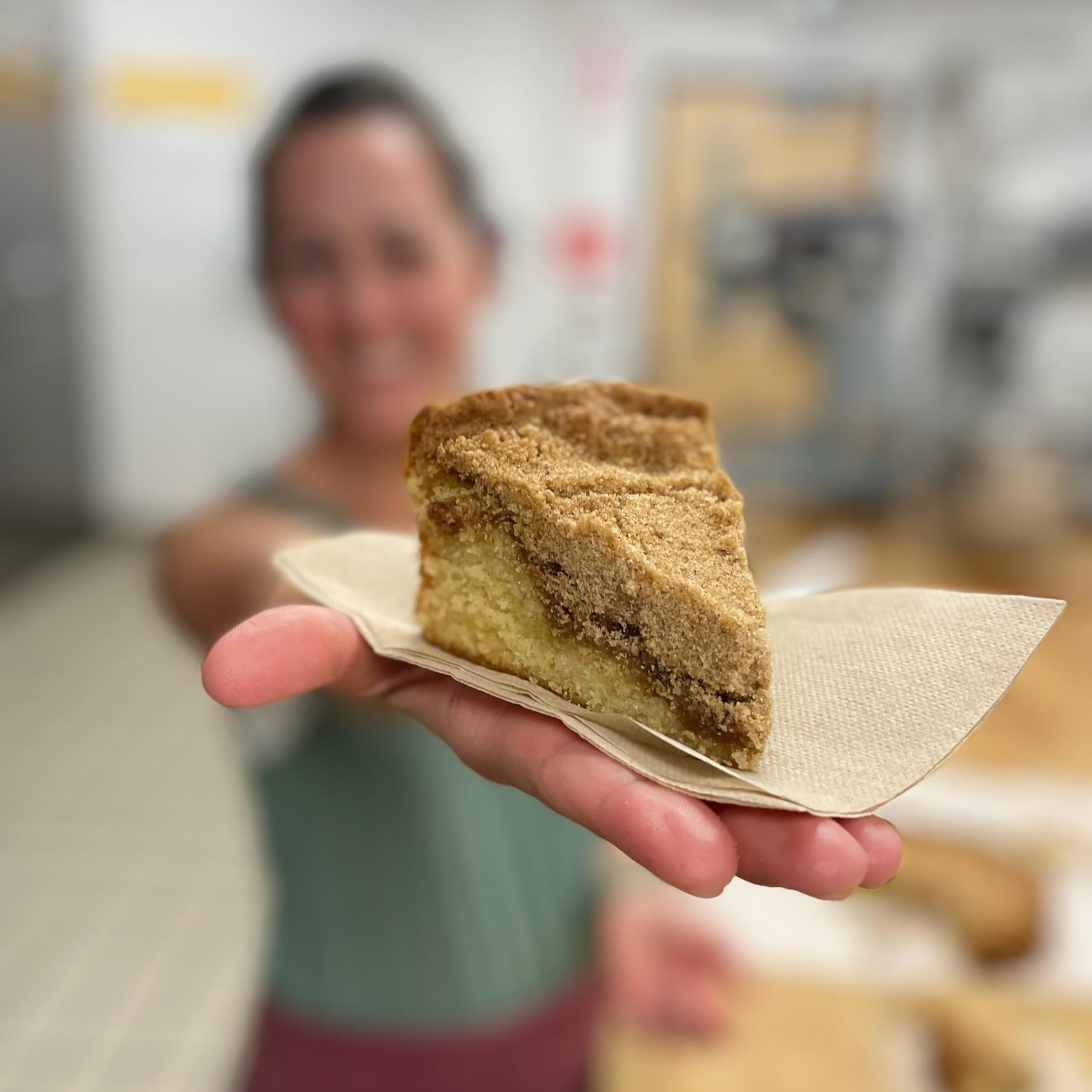 a hand holding a piece of bread