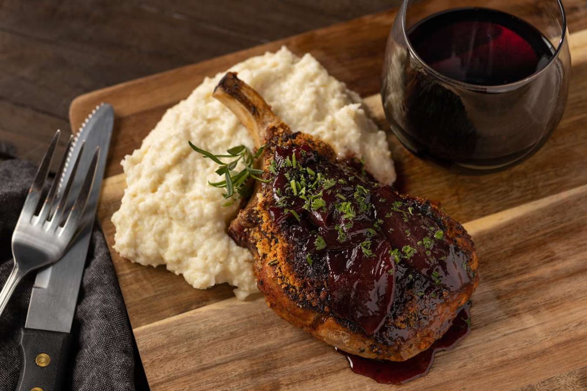 a plate of food sitting on top of a wooden cutting board