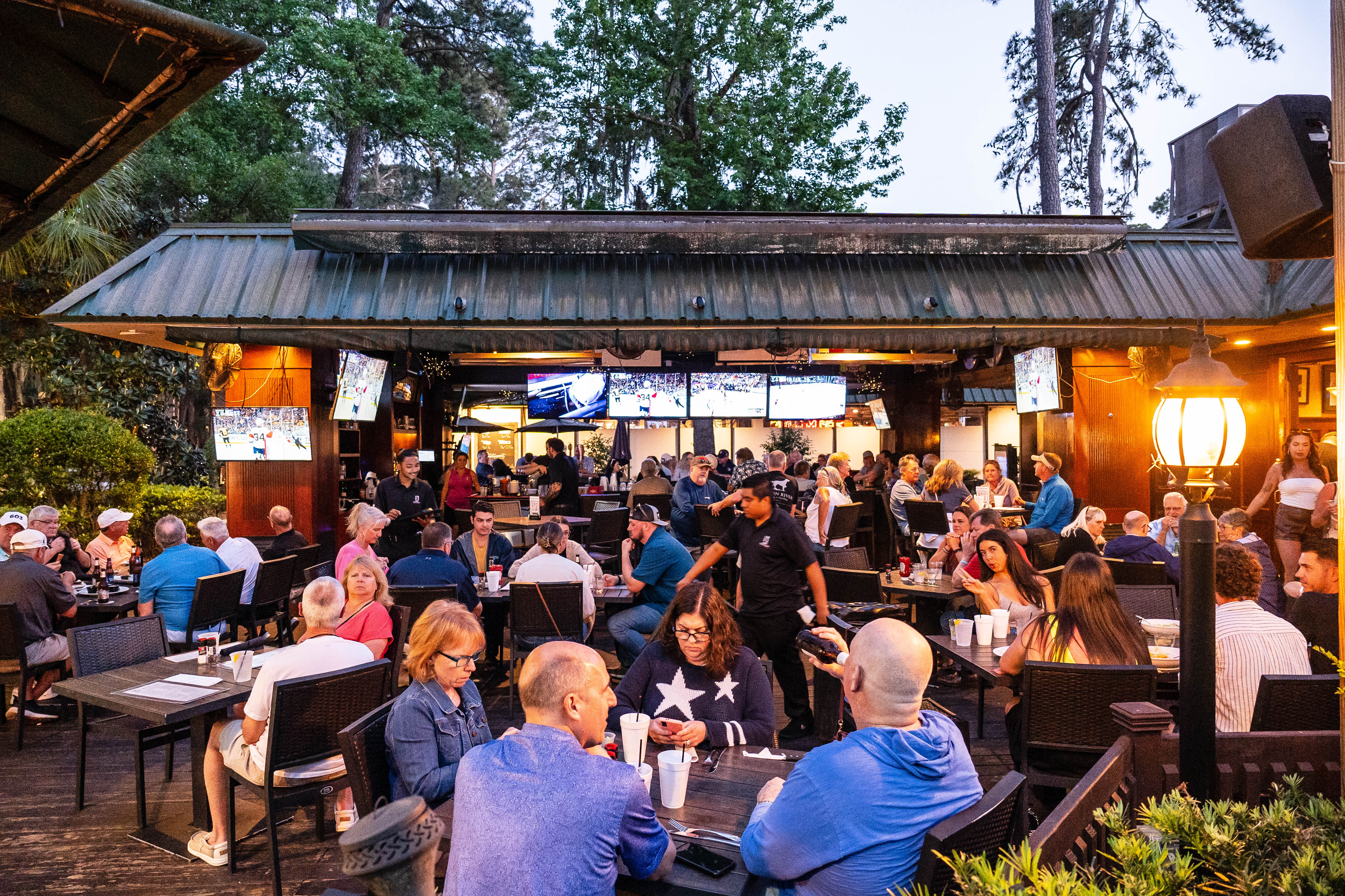 a group of people sitting at a picnic table