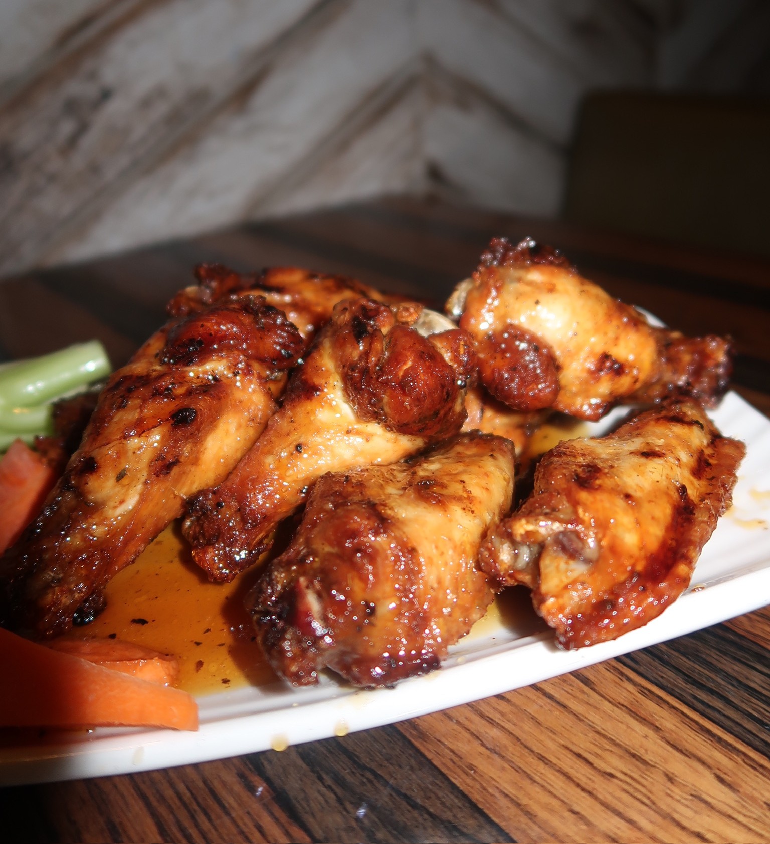 a plate of chicken wings and vegetables
