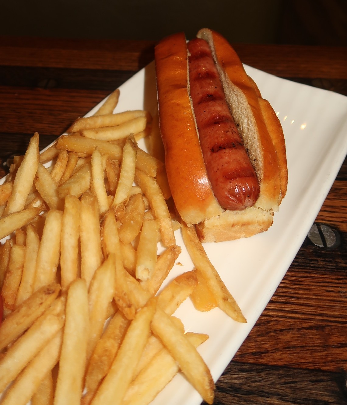 a hot dog and french fries on a plate