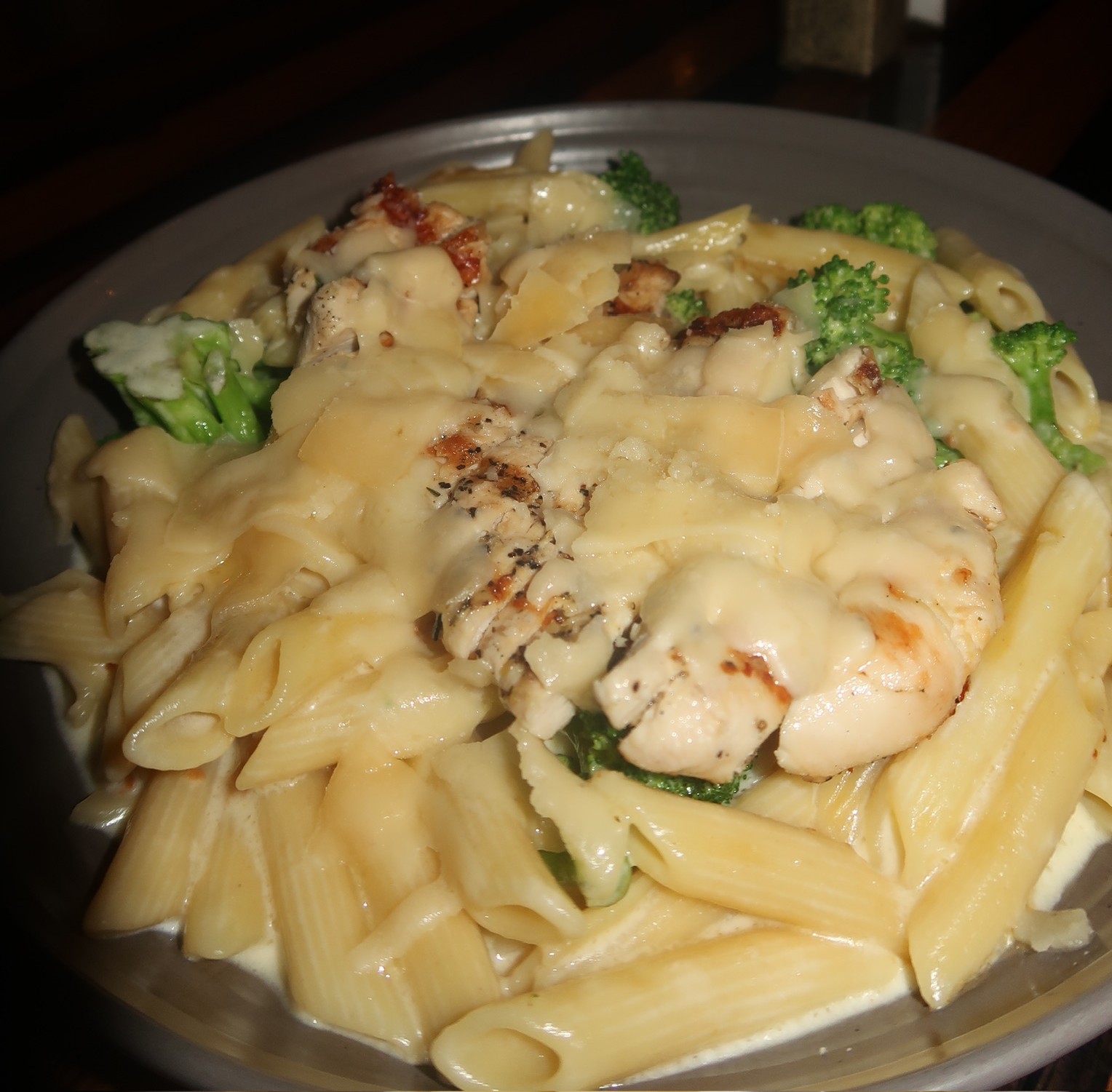 a plate of pasta with chicken and broccoli