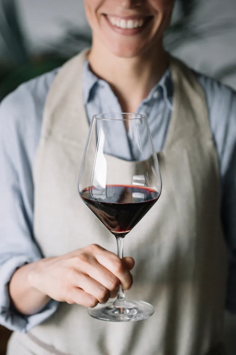 a person holding a glass of wine