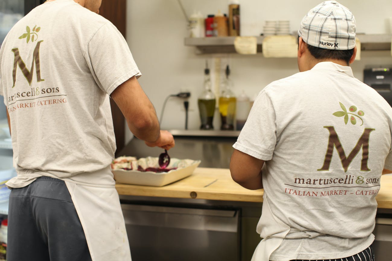 a man standing in a kitchen preparing food