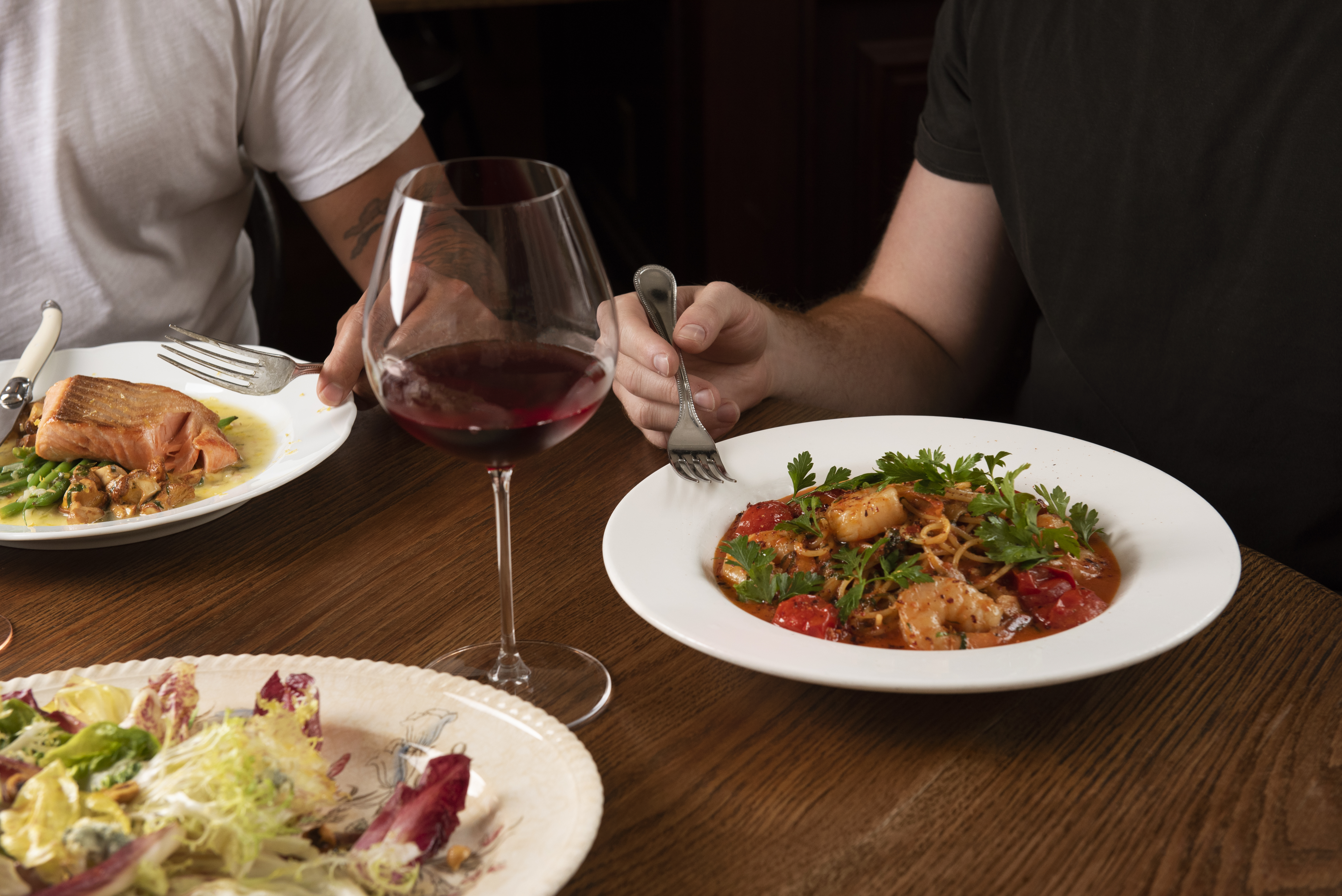a person sitting at a table with a plate of food