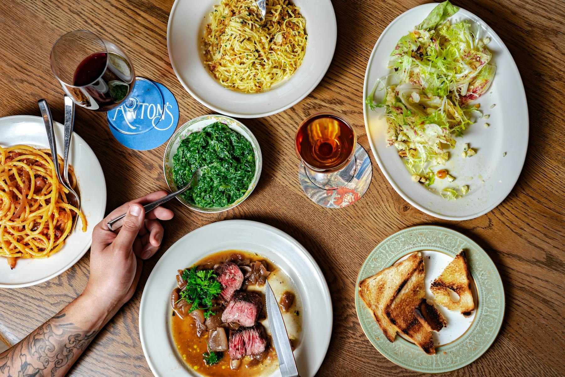 Collection of dishes, including Angel Hair Francese, Mixed Chicories, Hangar Steak Lorenz
