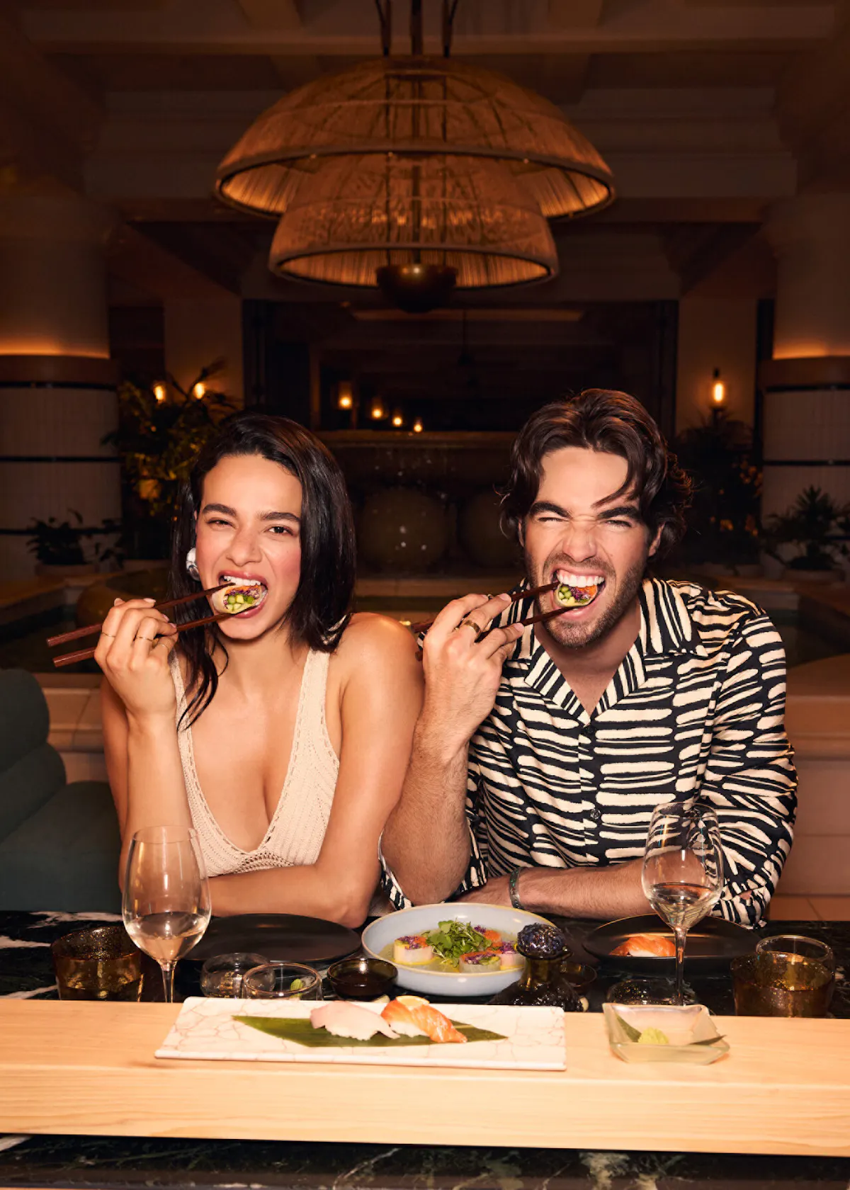 Aurora Perrineau et al. sitting at a table in a restaurant