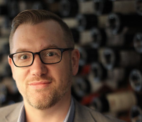a man wearing glasses and looking at the camera
