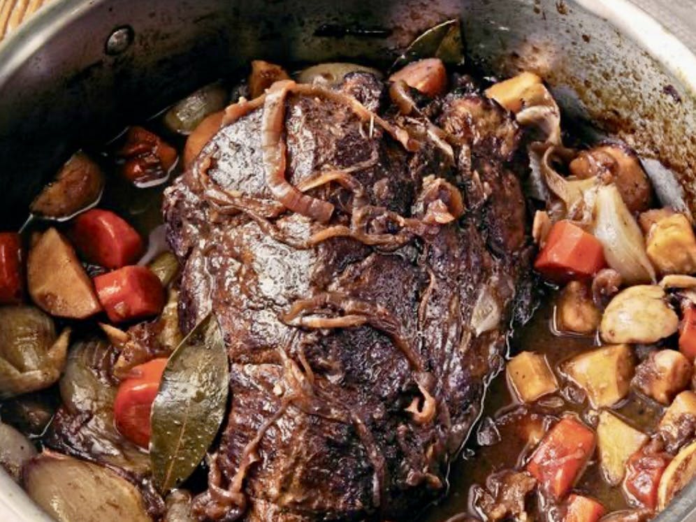 a pan filled with meat and vegetables