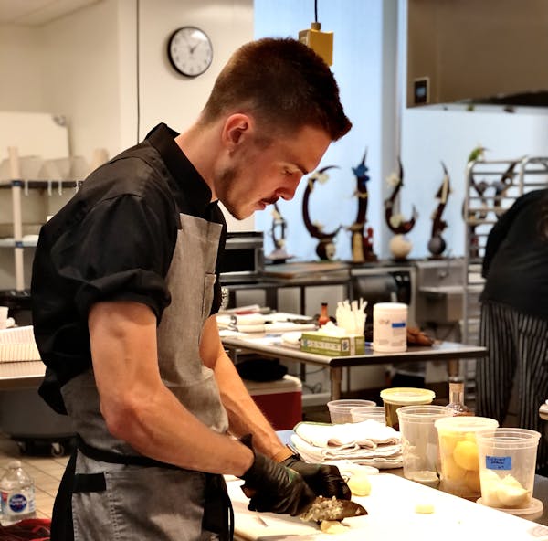 a man preparing food in a kitchen