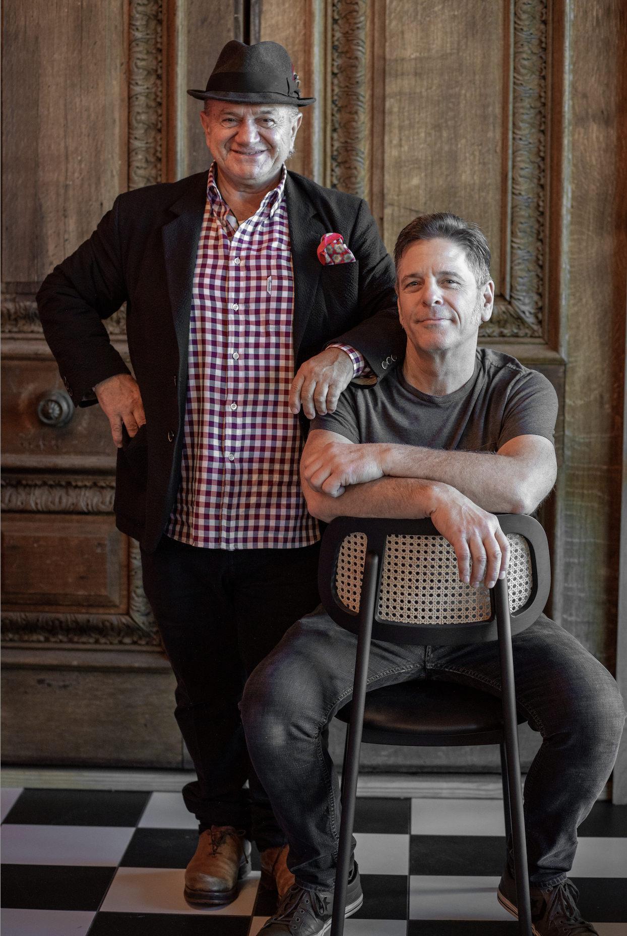 a man sitting in front of a group of people posing for the camera