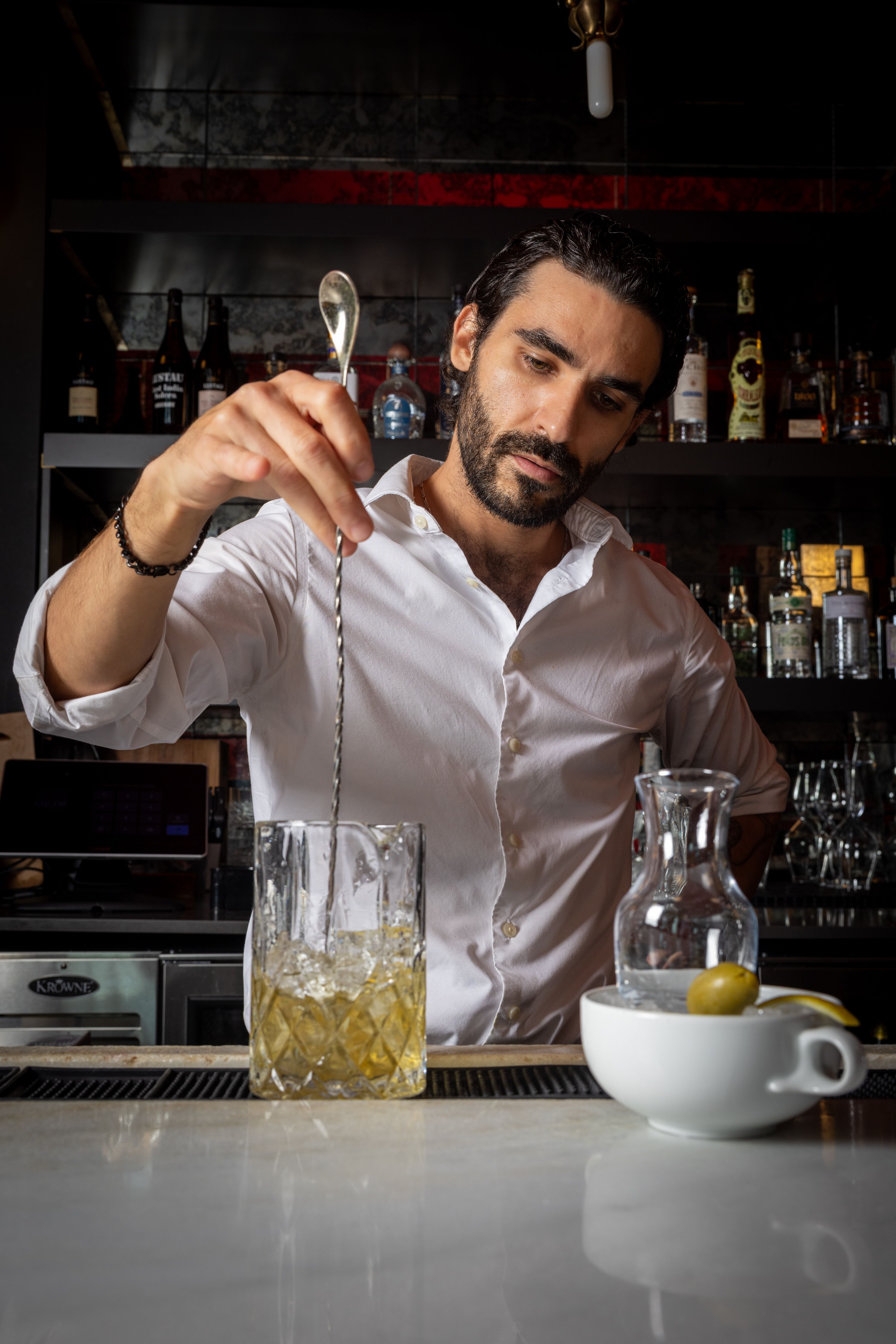 a man pouring liquid into a glass