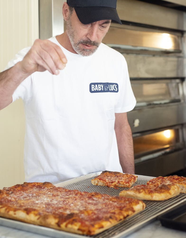 a man holding a pizza