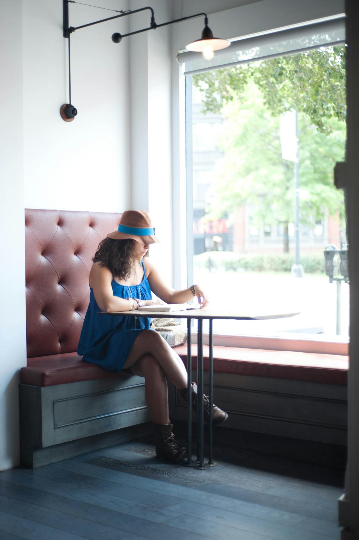 a person sitting on a bench in front of a window