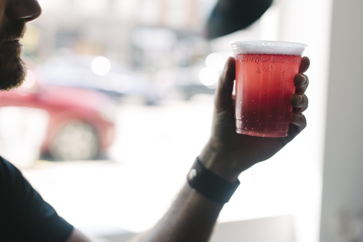 a hand holding a drink