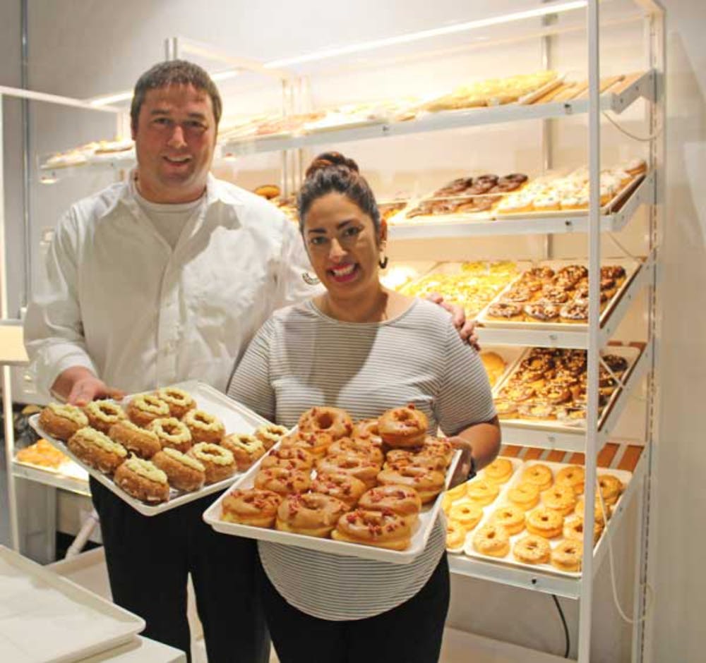 a person standing in front of a store filled with lots of food