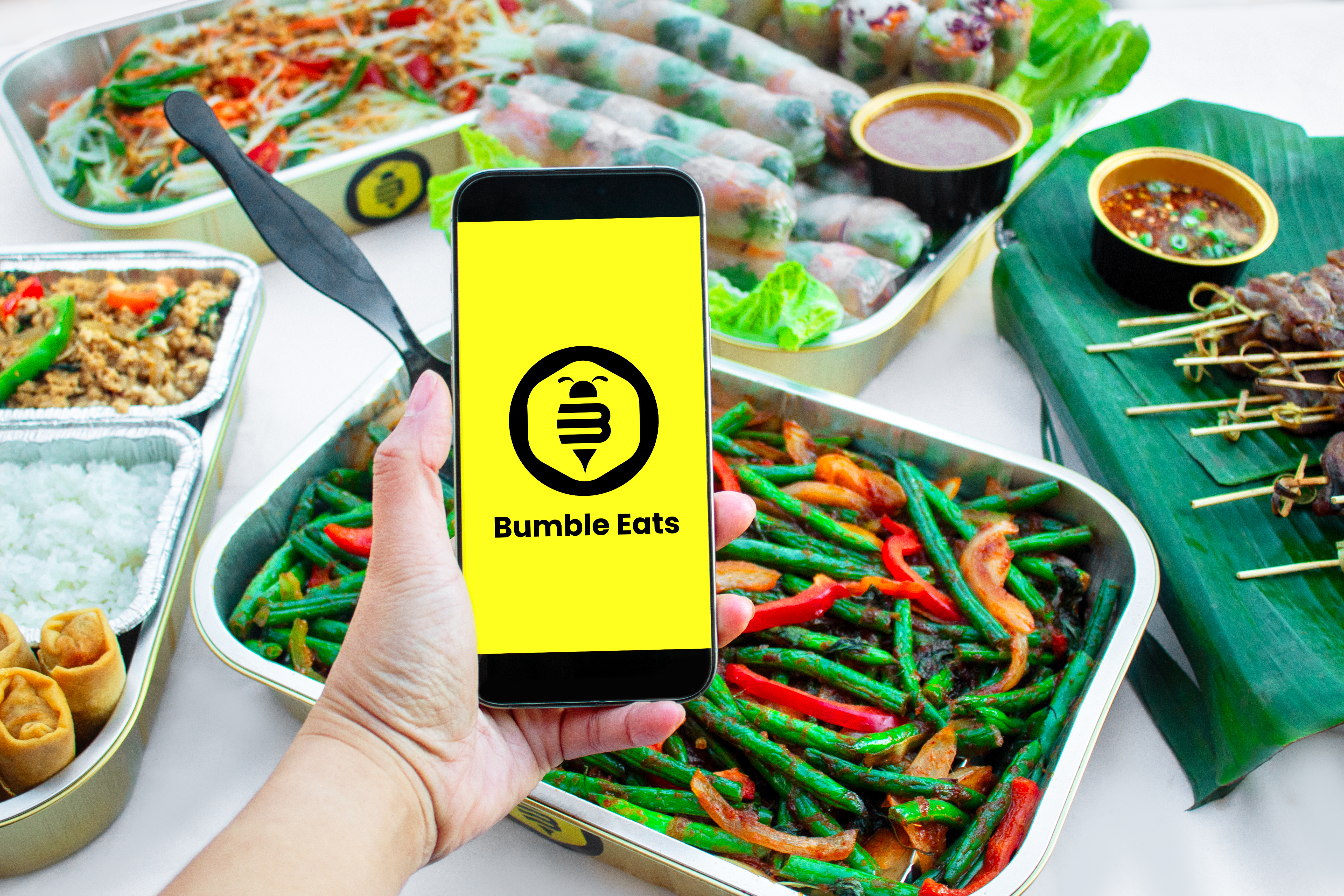 a hand holding a phone with a yellow screen