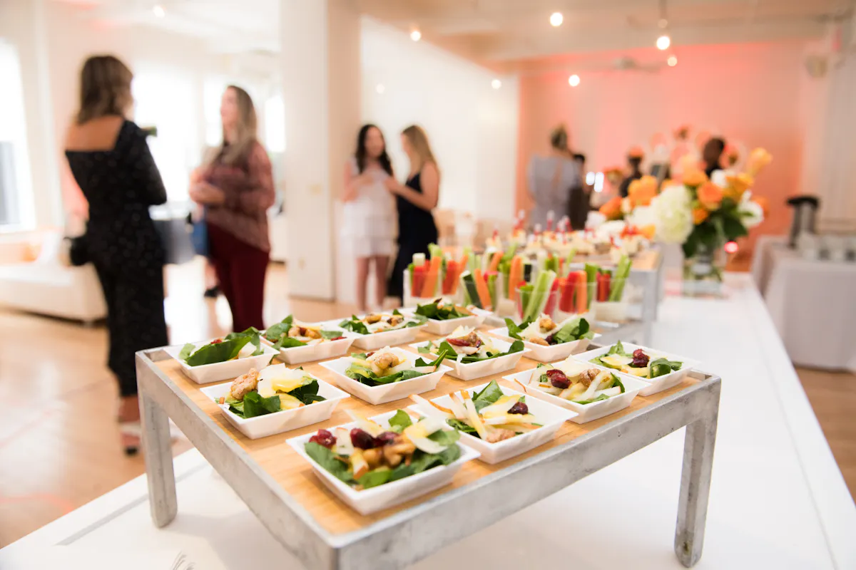 a group of people sitting at a table with a plate of food