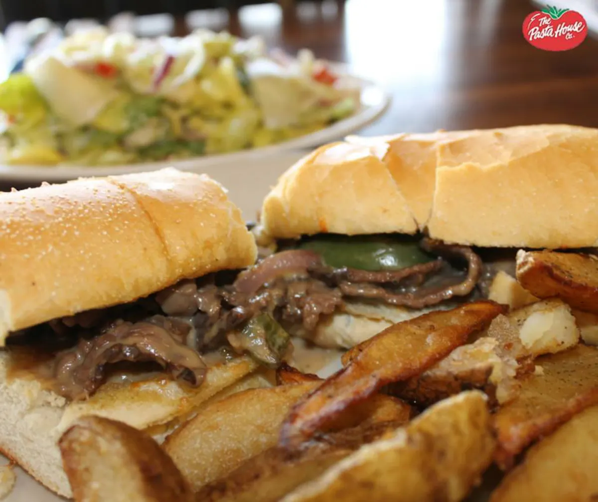a close up of a sandwich and fries on a plate