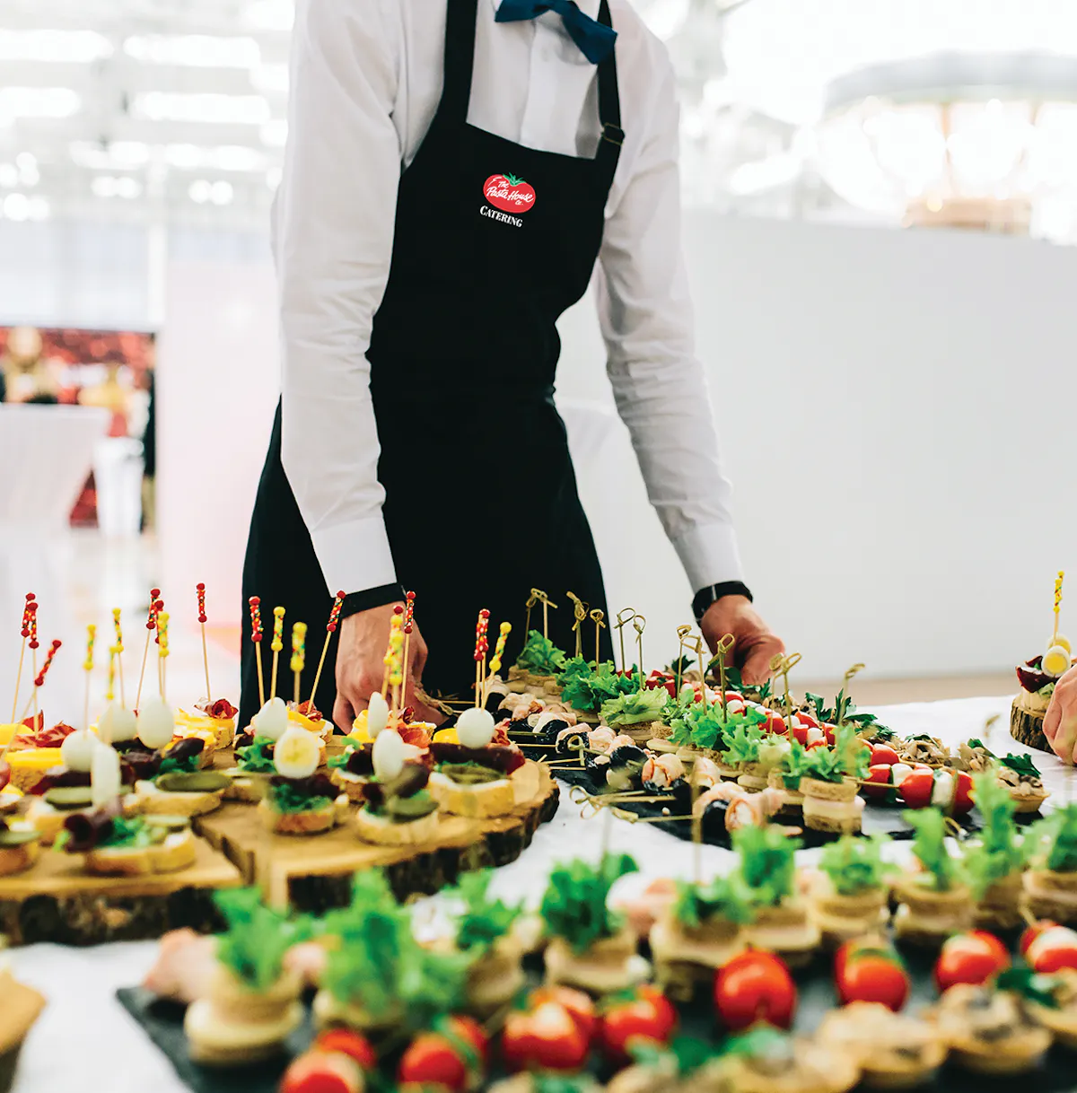 a person standing in front of a cake