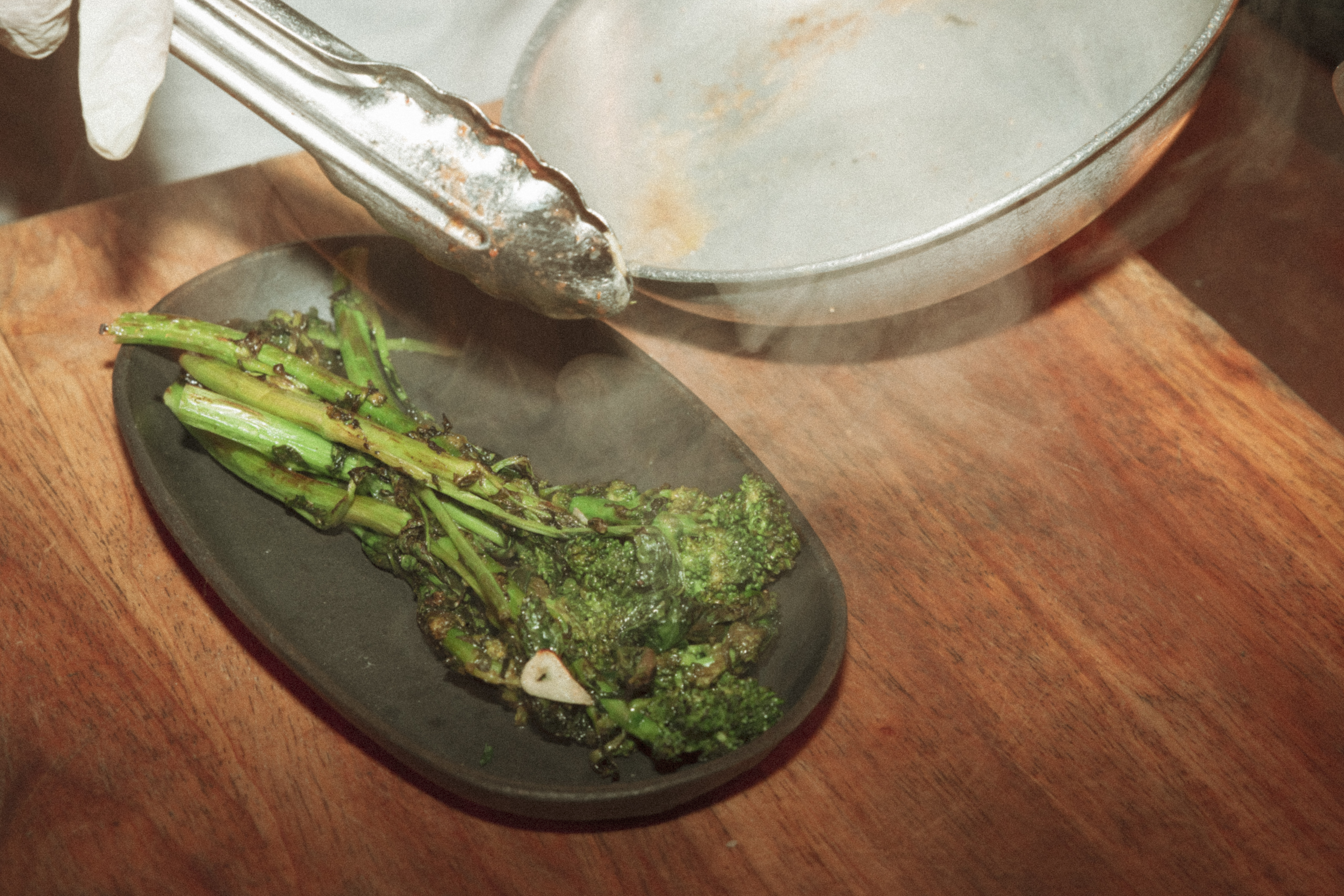 a plate of broccoli and a pan