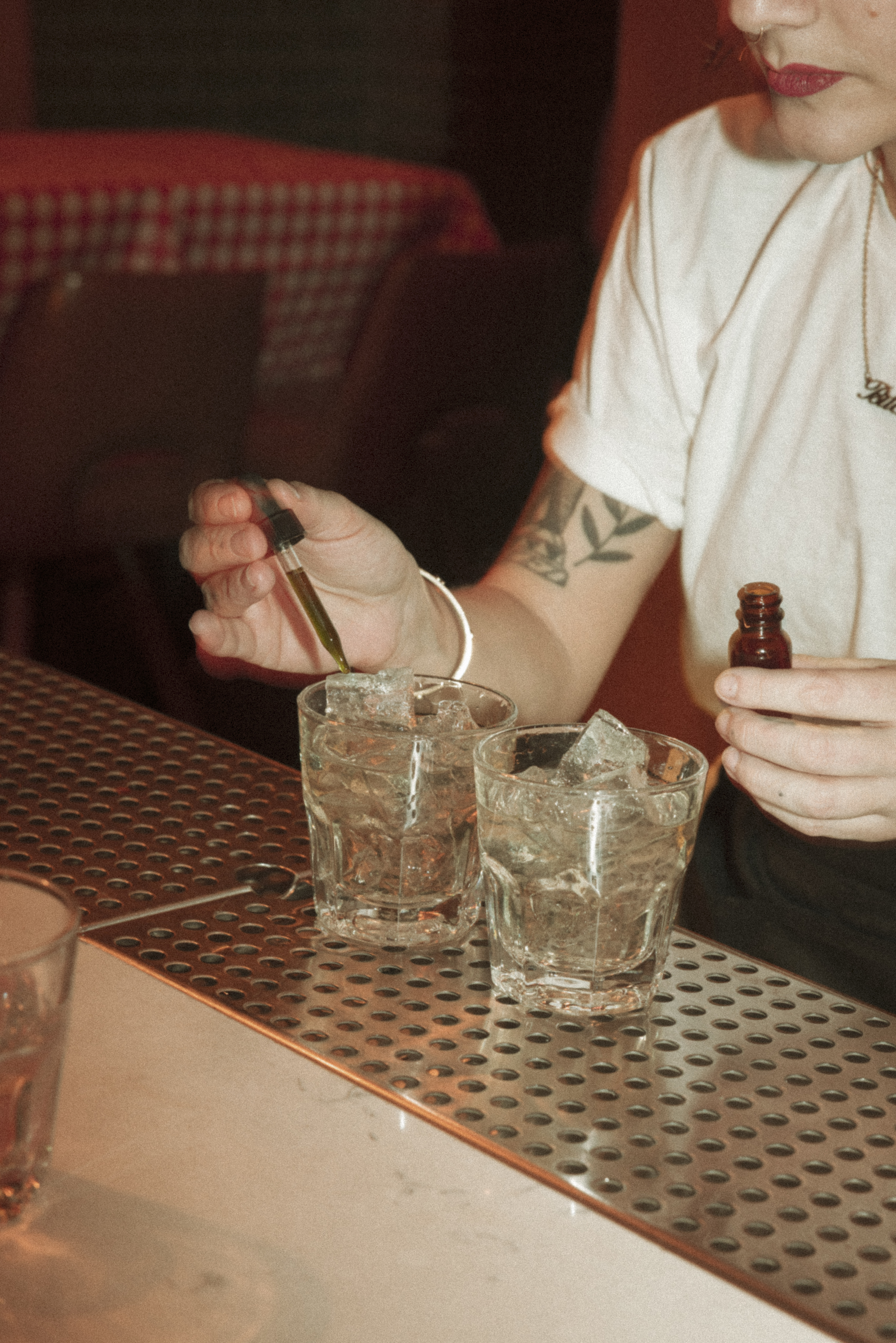 a person pouring liquid into a glass