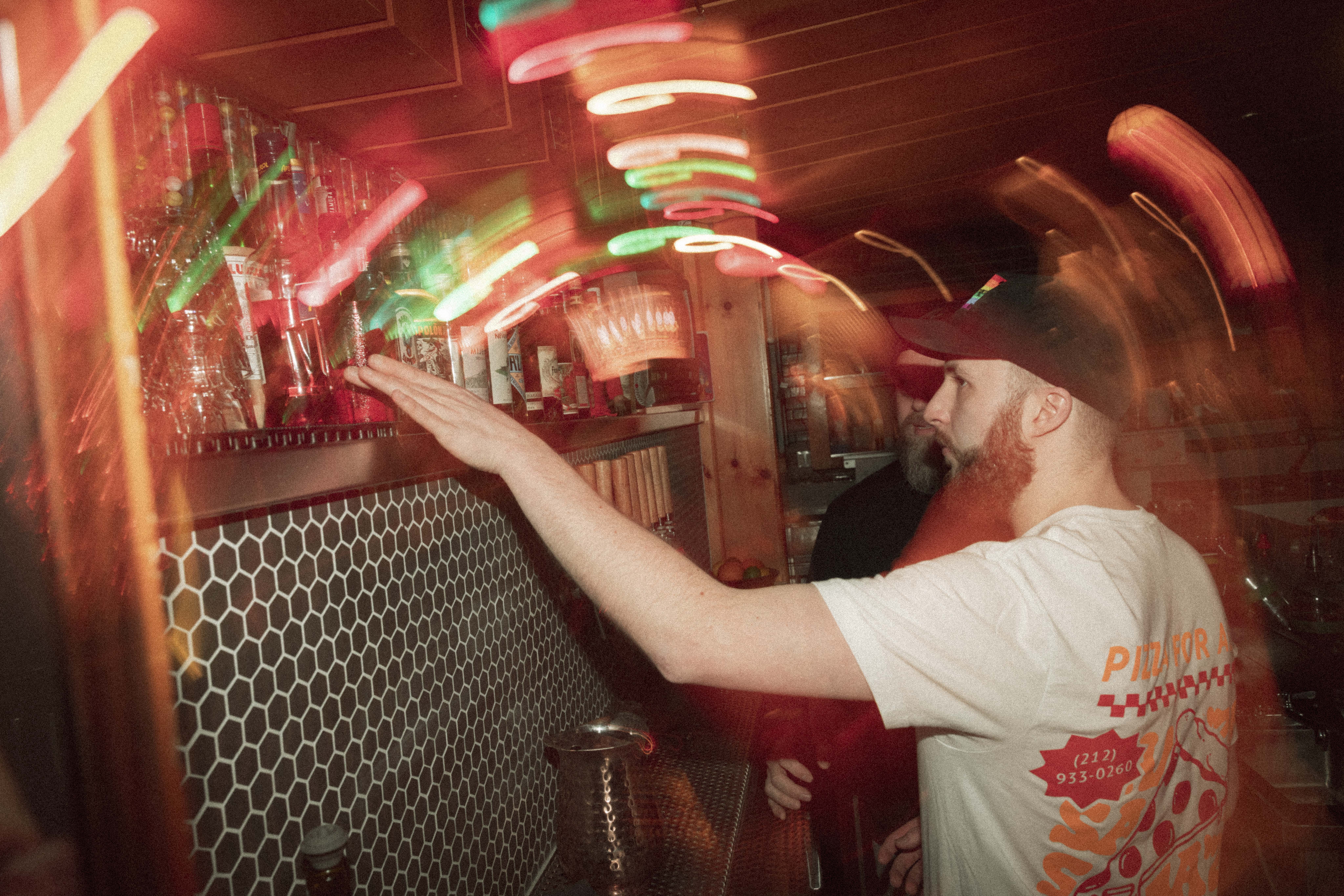a man reaching out to a bar
