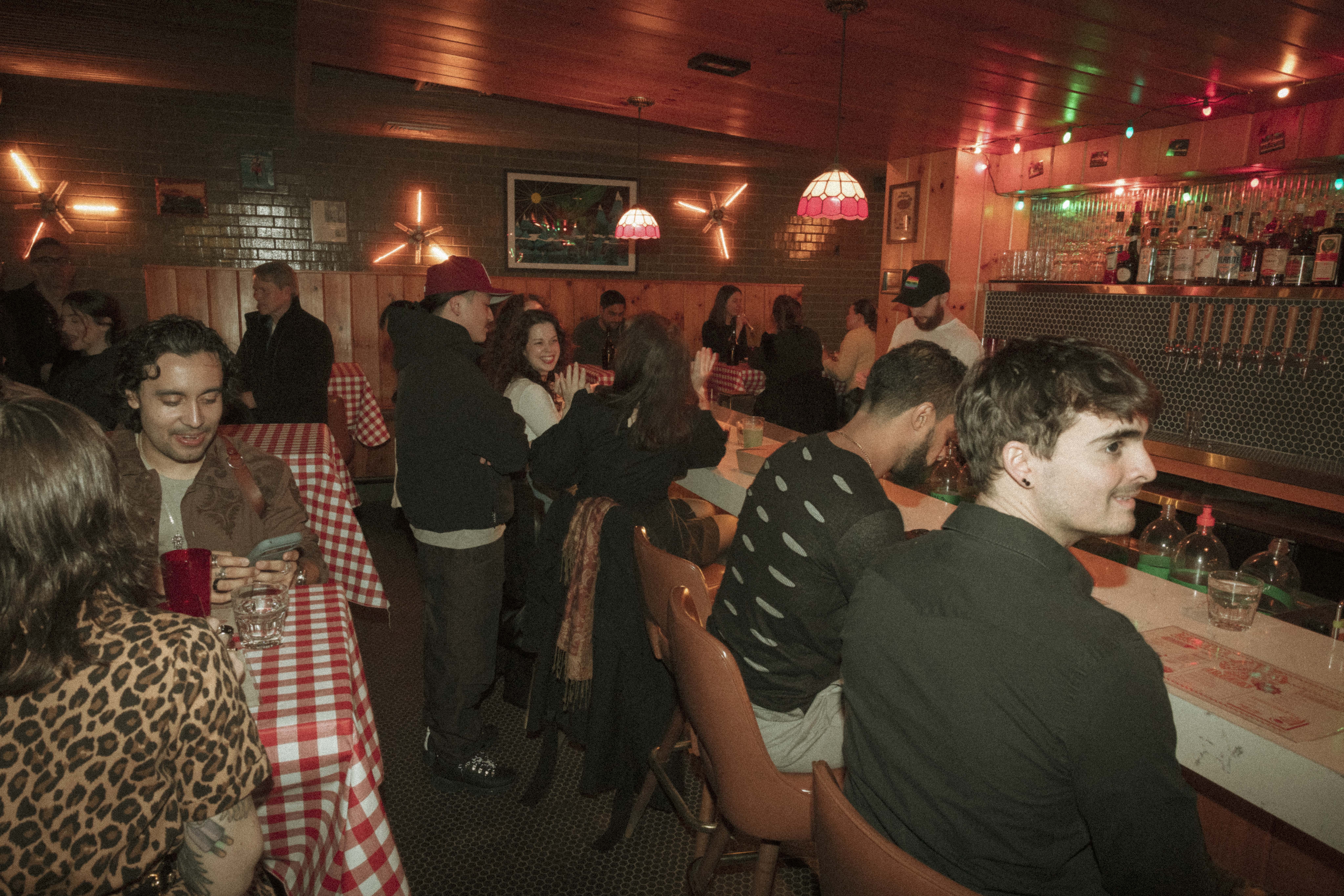 a group of people sitting at tables in a restaurant