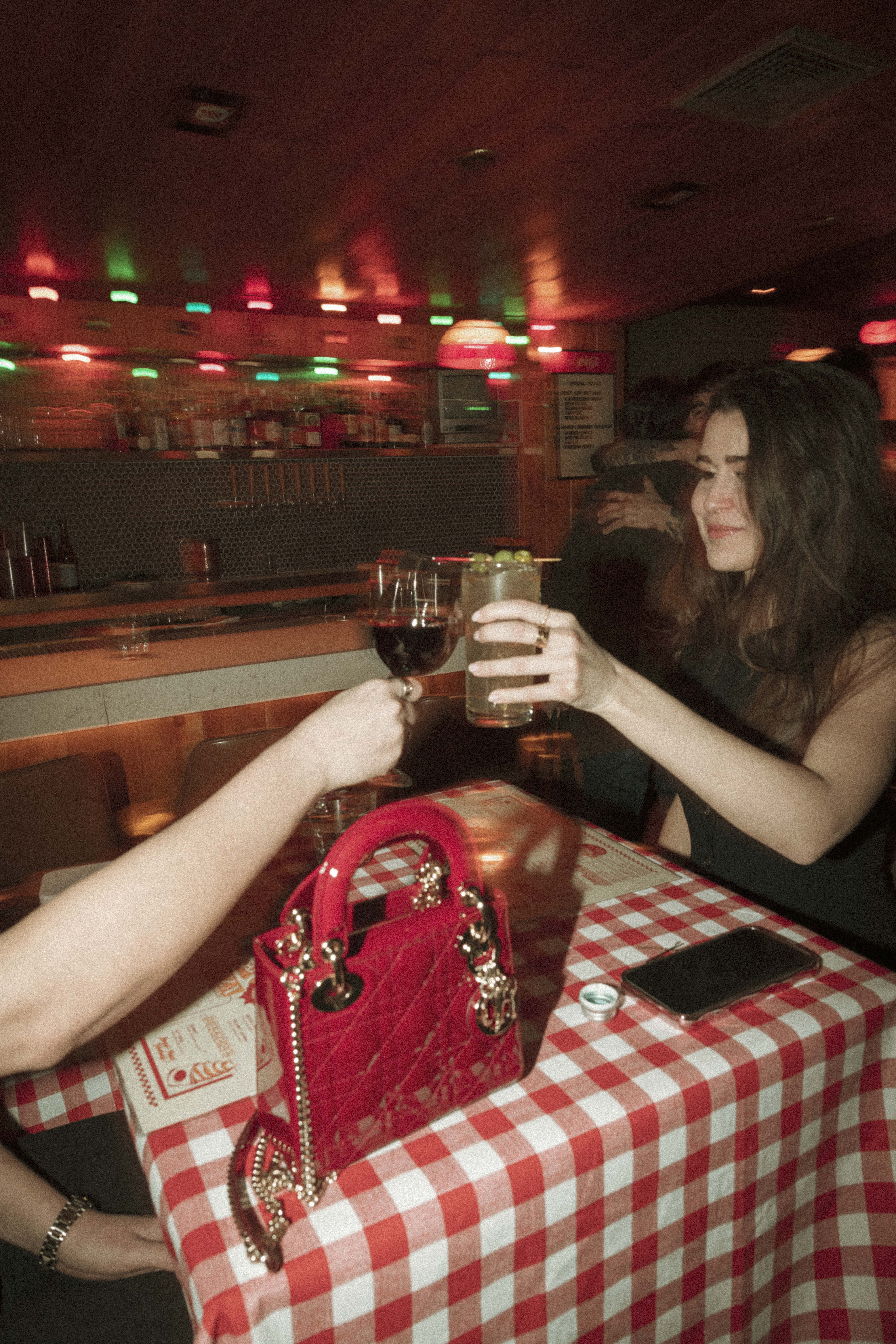 a woman holding glasses of wine
