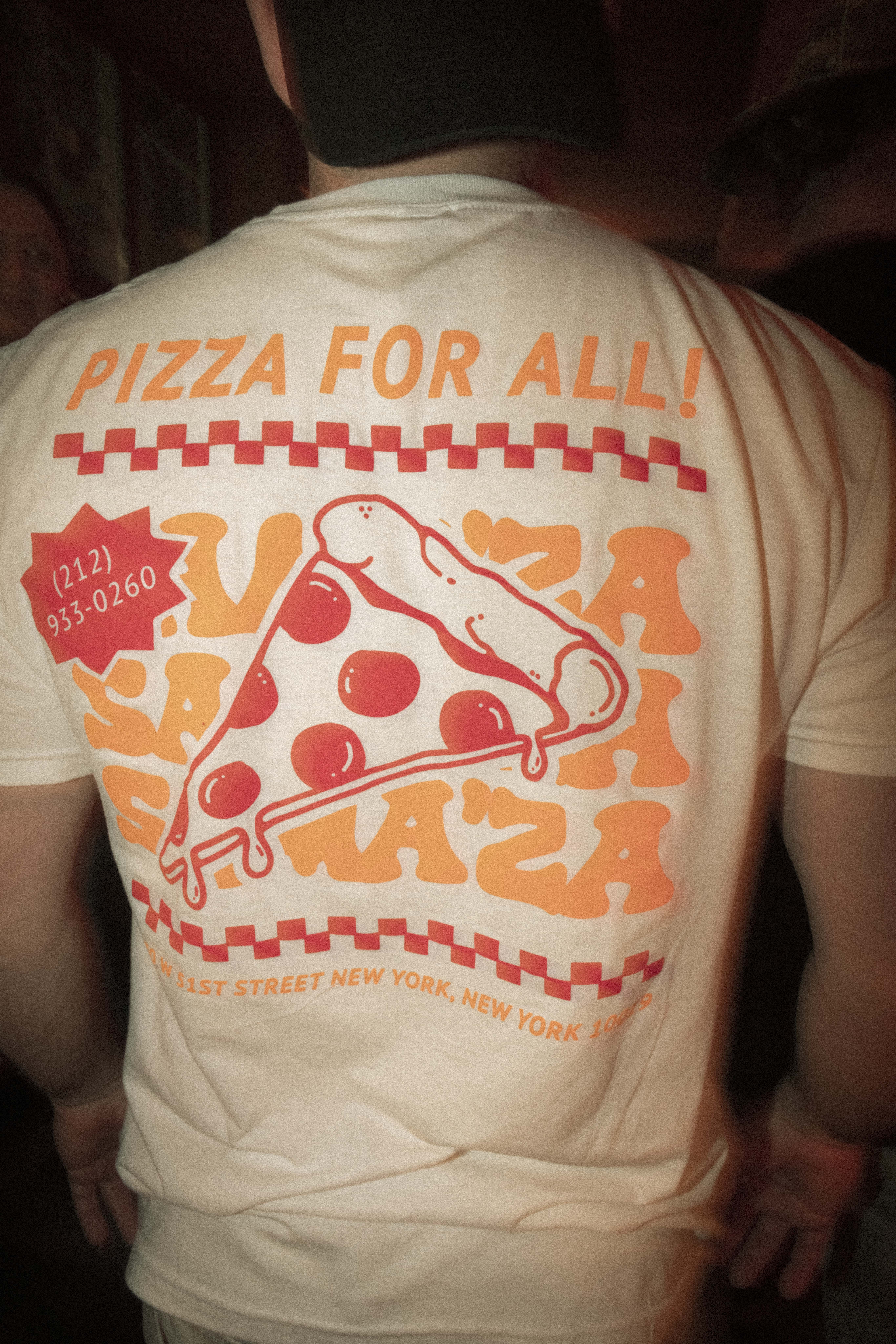 a person wearing a white shirt with a pizza on it