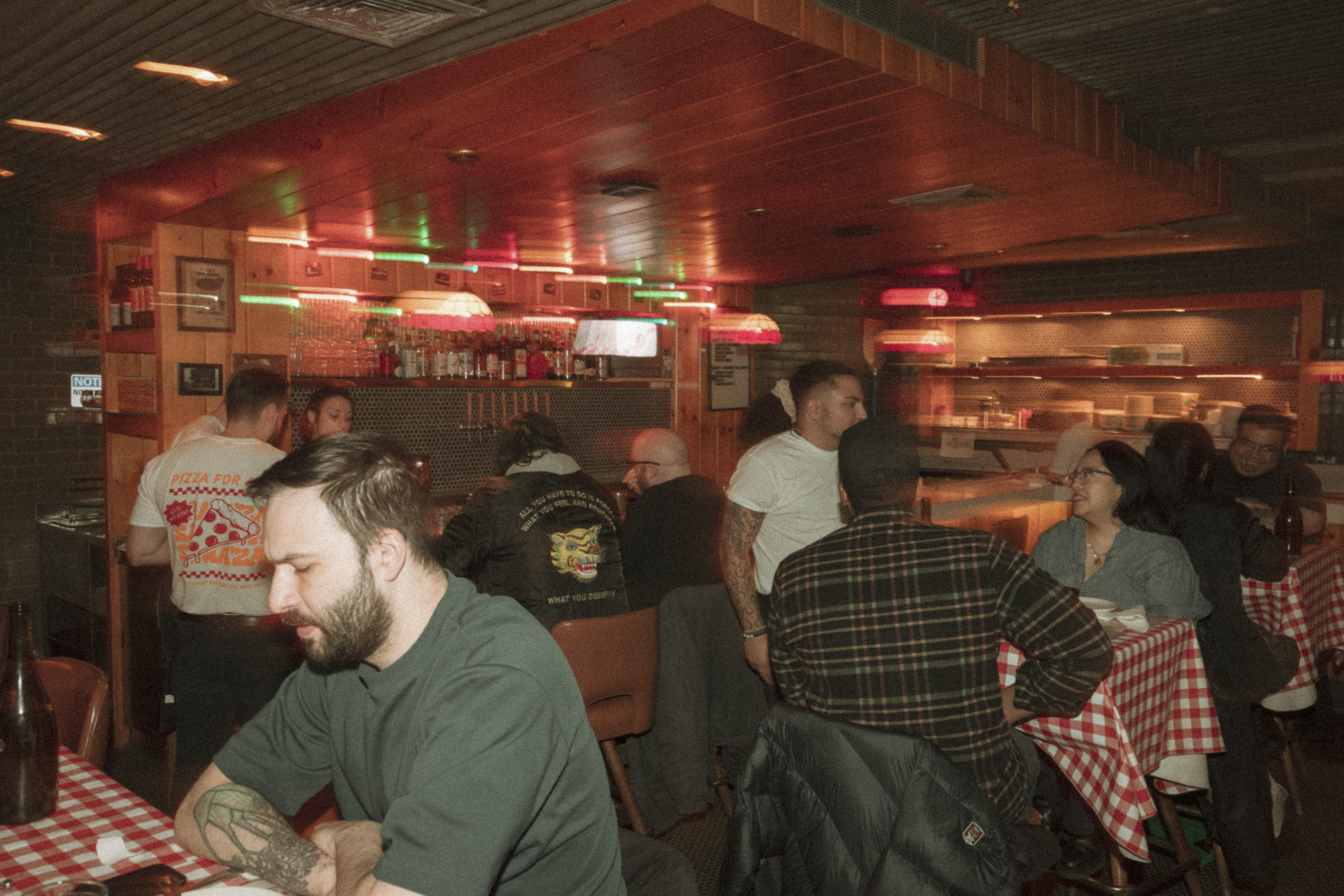 a group of people sitting at tables in a restaurant