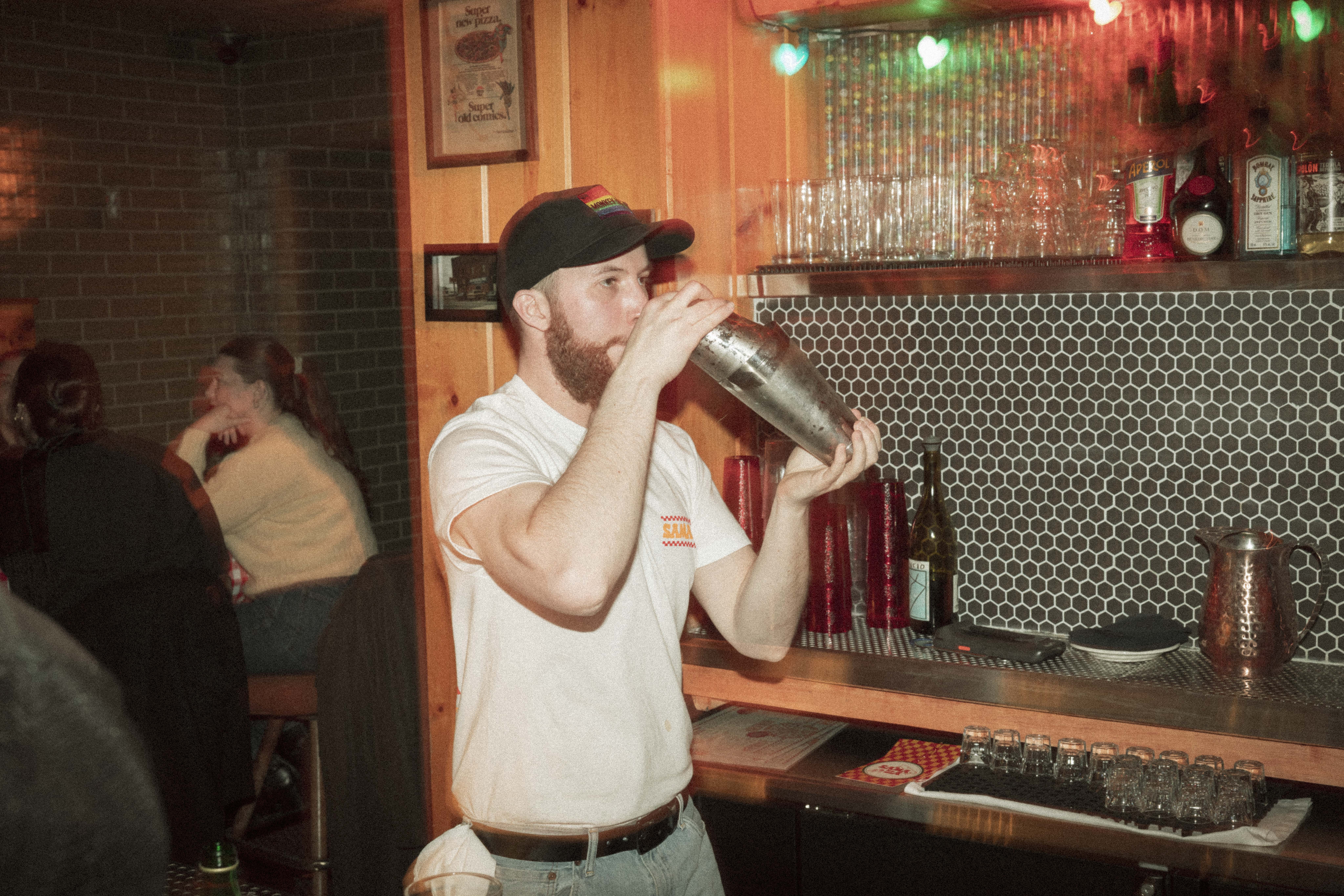 a man drinking from a shaker